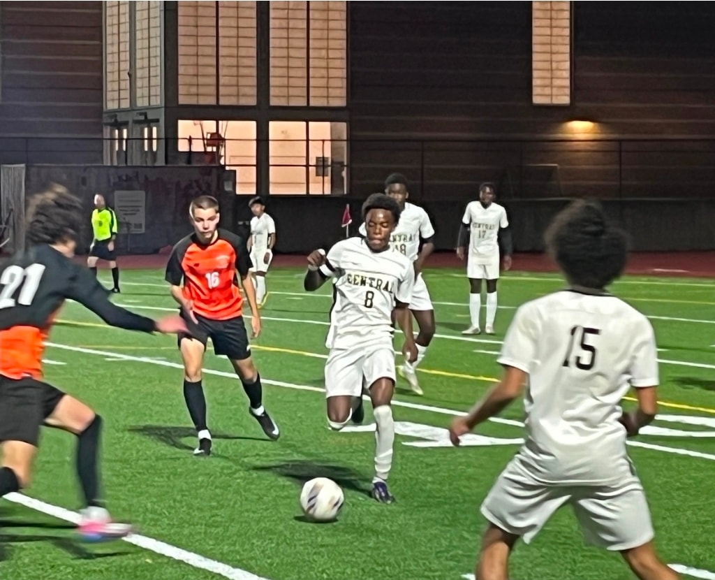 Springfield Central boys soccer players compete on an indoor field under the lights