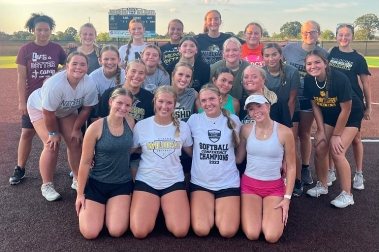 Neosho Wildcats softball team poses together at the field before the 2026 season